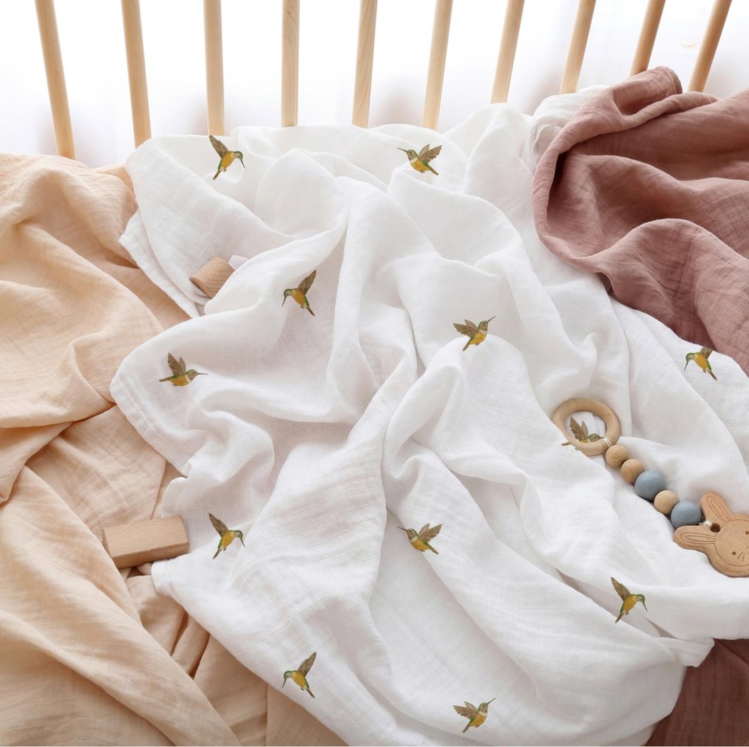 Hummingbird-print muslin in a wooden crib